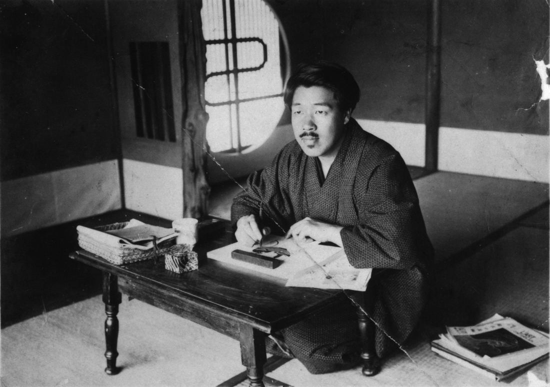 Black and white photo of animation pioneer Seitaro Kitayama at a low desk