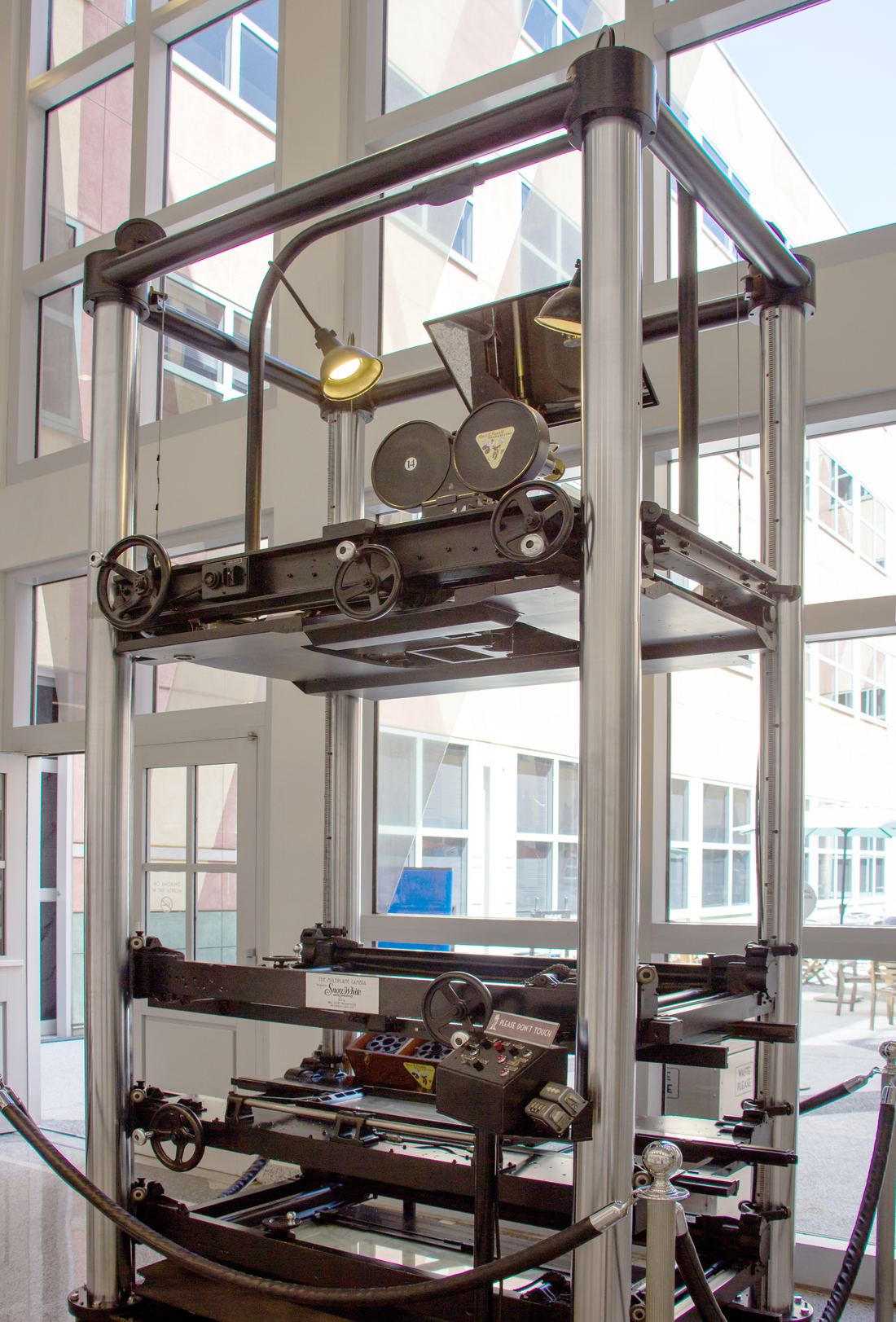 A tall multiplane animation camera stand built in 1937, shown in a museum