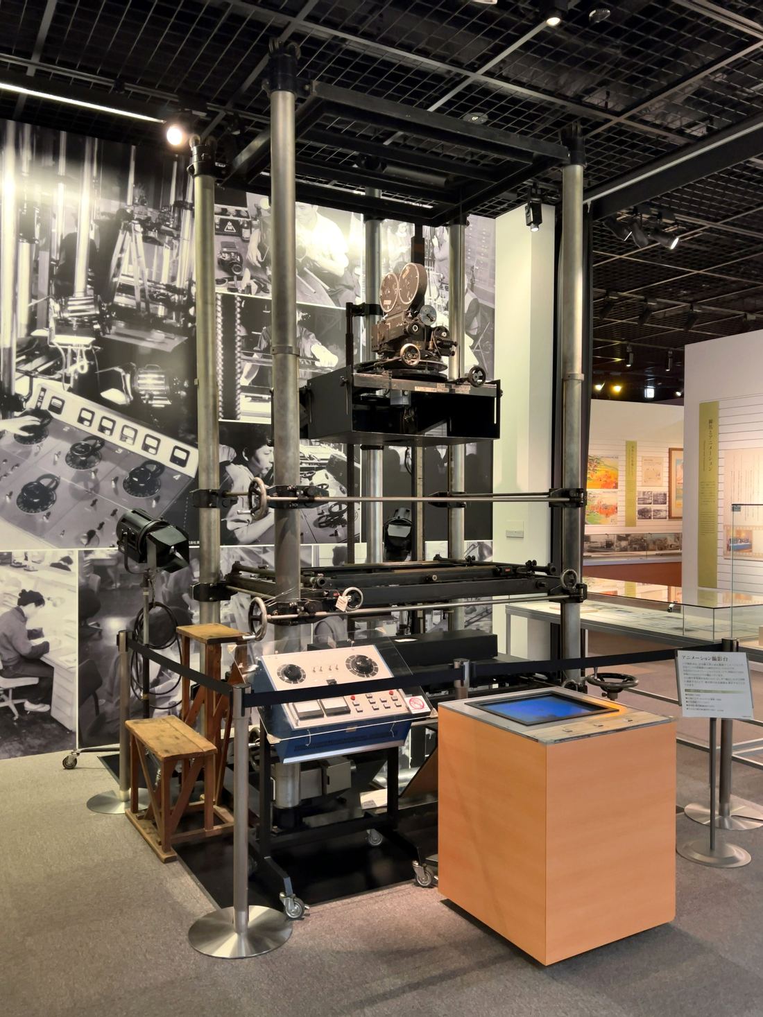A vintage animation filming stand with a camera above a copy table, in a museum