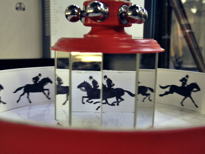 A praxinoscope with mirrors at the centre reflecting a strip of galloping horse pictures