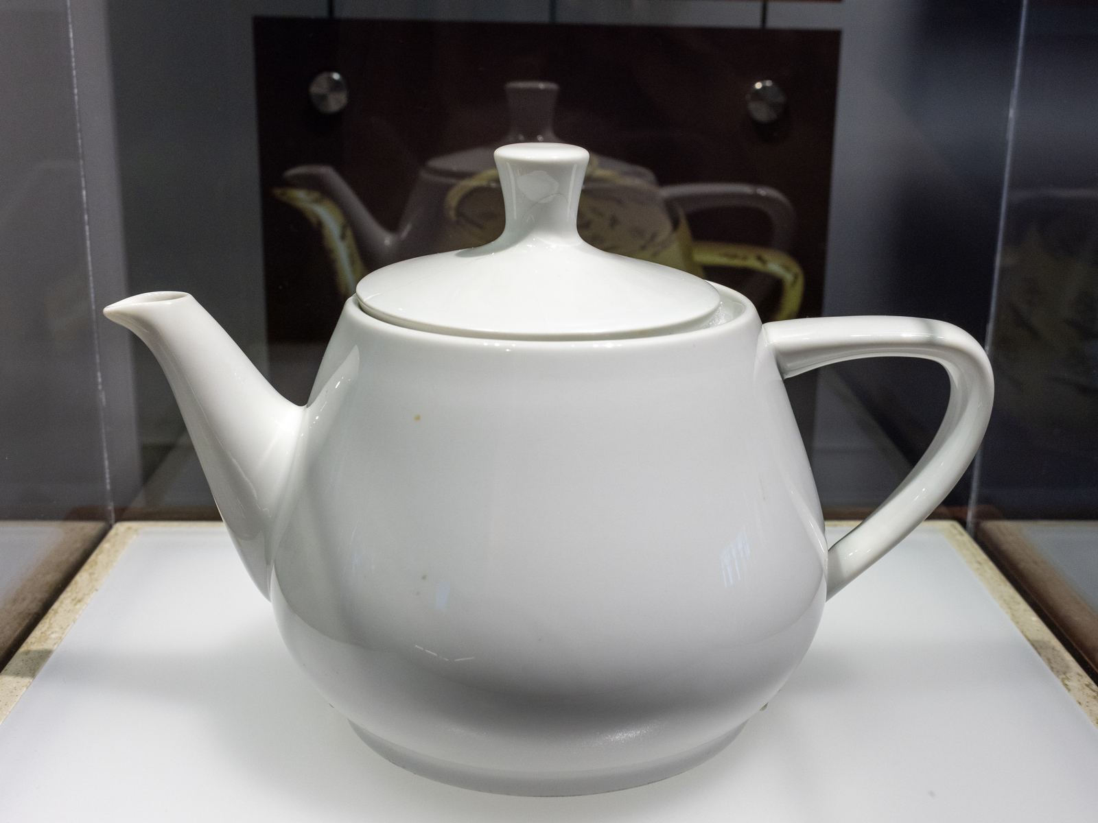 The real white teapot used to create the Utah teapot 3D model, in a museum case