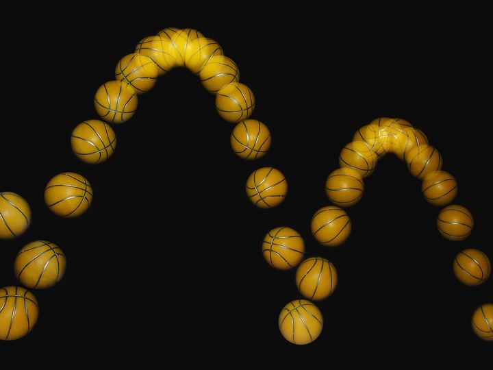 Stroboscopic photo of a basketball bouncing, showing its path in many positions