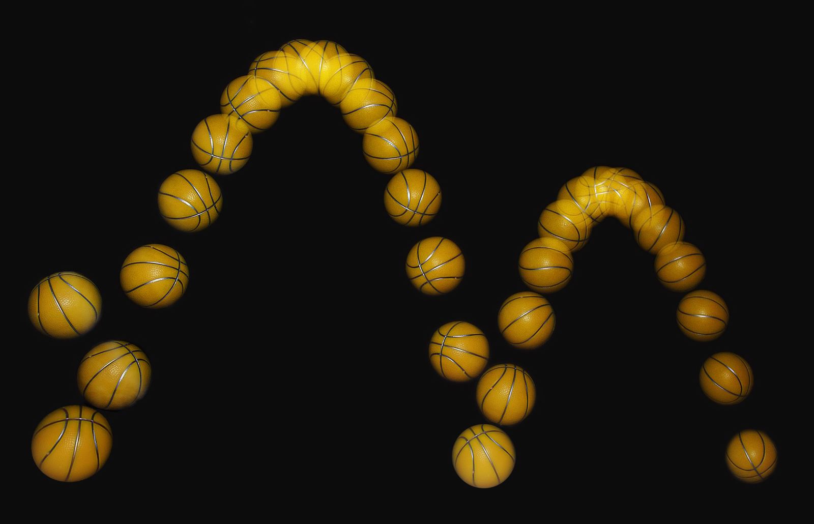 Stroboscopic photo of a basketball bouncing, showing its path in many positions